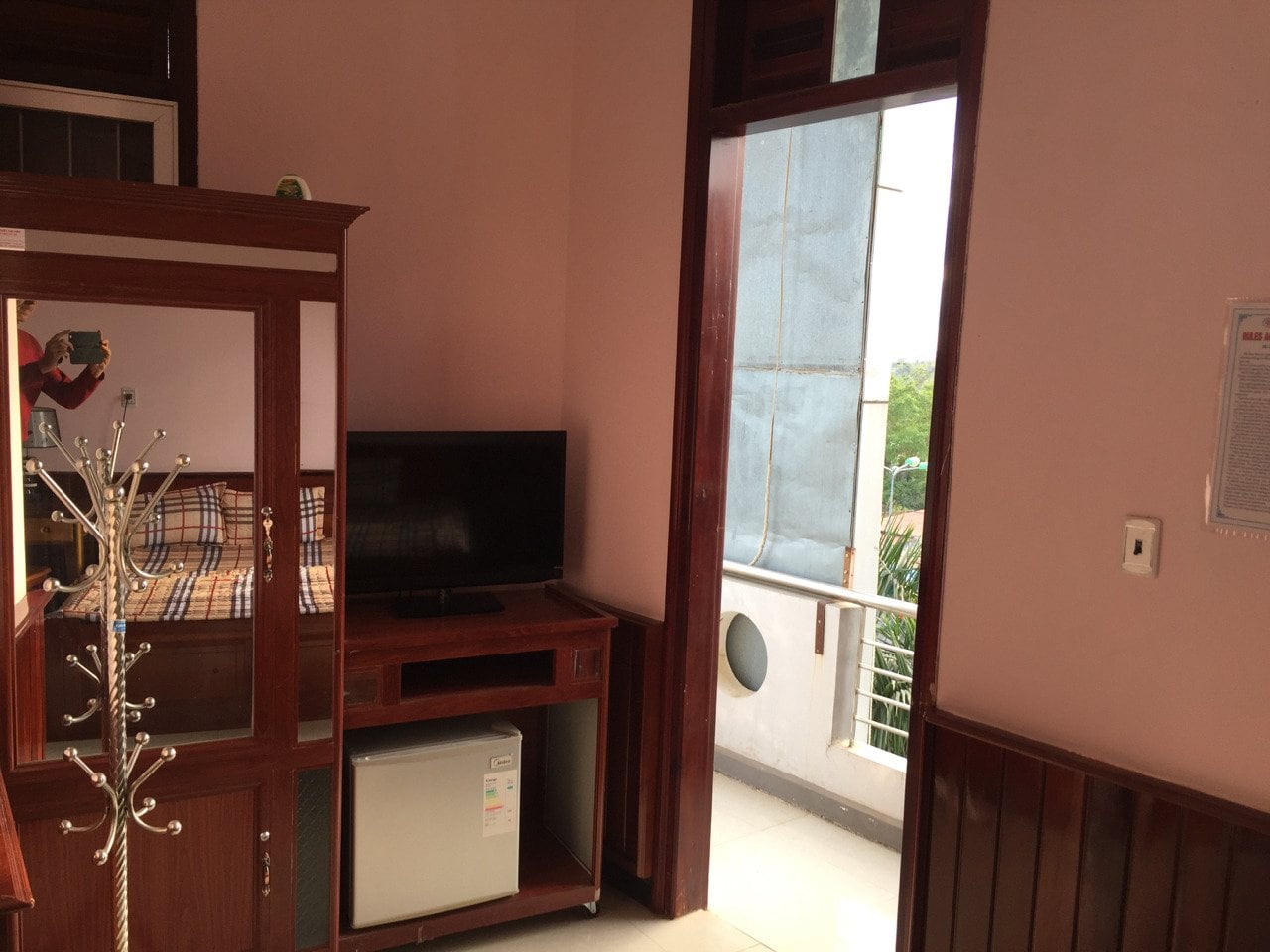 TV, fridge, closet and door to the balcony