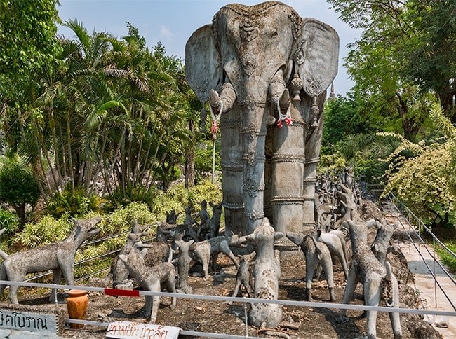 Elephant wading through a pack of anthropomorphic dogs (which teaches people to not be bothered by gossip)