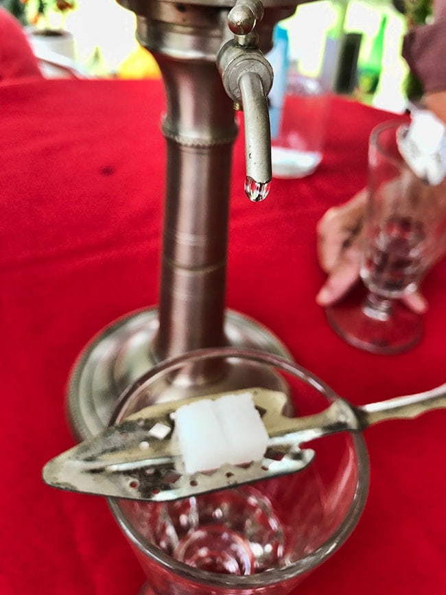 Now you open the tap - but only a bit so the water drips over the sugar into the Absinthe